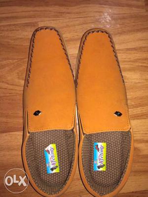 Pair Of Orange Slip On Shoes