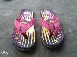 Pair Of Pink-black-and-yellow Rubber Flip Flops