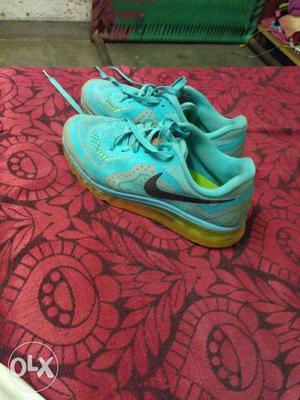 Pair Of Teal Nike Running Shoes