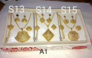 Three Gold Pendant Necklaces And Earrings