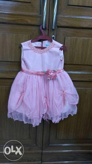 Peach coloured size 20 party frock for baby girl.