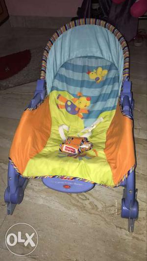 Baby's Yellow, Blue, And Orange Bouncer Seat