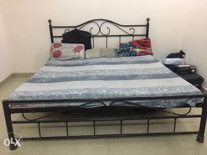 Black Metal Bed With Grey Bedspread