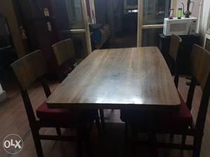 It's 4 seater dining table made of wood.
