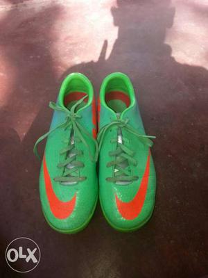 Green-and-orange Nike Mercurial