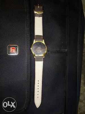 Round Gold Case Watch With White Strap