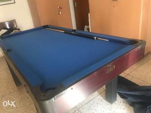 Blue And Brown Billiard Table With Cue Sticks