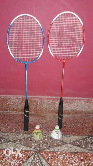 Two Blue And Red Badminton Rackets