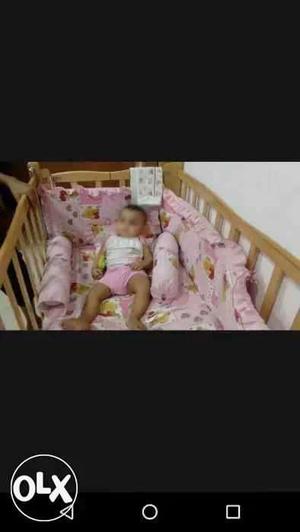 1yr old Baby Brown Wooden Crib With pink mattress, side