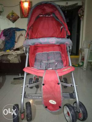 Baby's Red And Gray Stroller