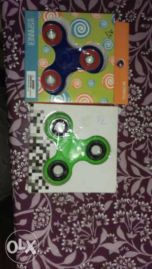 Blue And Green Fidget Spinners In Boxes
