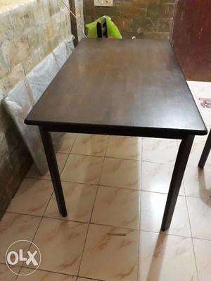 Brown color 4 seater dinning table of compressed wood