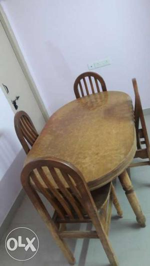 Oval Brown Wooden Dining Table With Four Chair Set