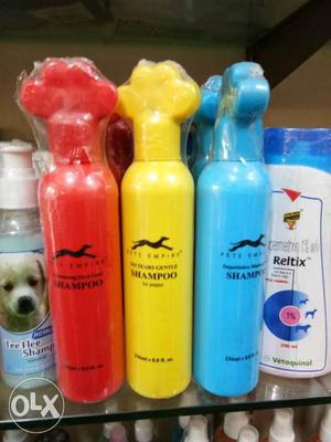 Three Red, Yellow, And Blue Dog Shampoo Bottles