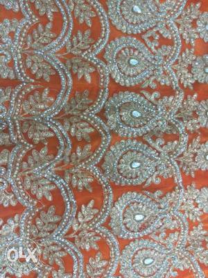 Embroidered lehenga with orange n pink colour.