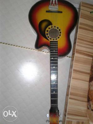 Black, Red And Beige Acoustic Guitar
