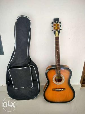 Brown And Black Acoustic Guitar With Black Gig Bag