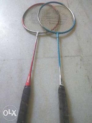 Two Red And Blue Badminton Rackets