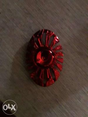 A red spinner but one side is crushed