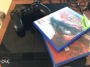 Black Sony PS4 Game Console And Two Game Cases