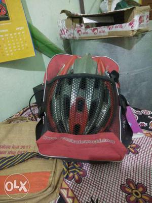 Gray And Red Bicycle Helmet With Bag