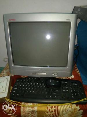 Grey CRT Monitor And Black Cordless Keyboard With Mouse