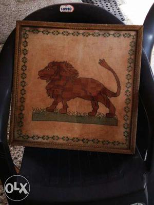 A picture of a lion weaved in a cloth.