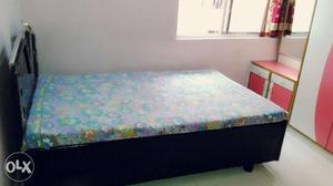 Black Wooden Bed With Floral Mattress