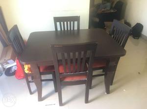 Rectangular Brown Wooden Dining Table With Four Chairs