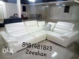 White Leather Corner Sofa With Throw Pillow