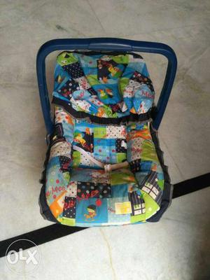 Baby's Blue, White, And Green Carrier Seat