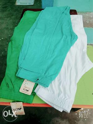 Pairs Of Teal, Green, And White Pants
