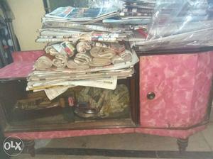 Red Wooden Cabinet And Newspaper