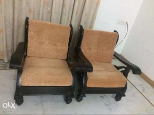 Two Brown Wooden Armchairs With Pads