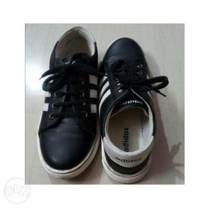 Adidas black shoe with white straps. In a new