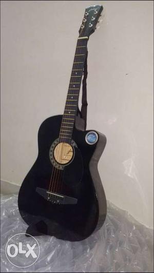 Black Accoustic Guitar. In Completely Fine
