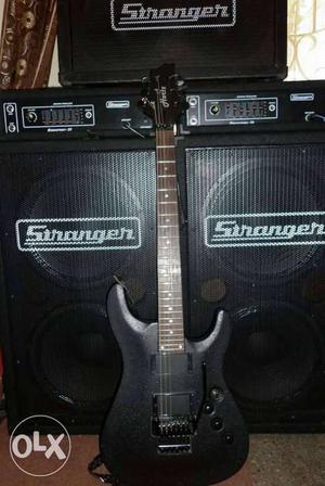 Black Electric Guitar With Two Stranger Amplifiers