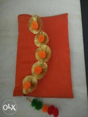 Orange pom pom clutch