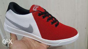 Paired Red, White And Black Nike Low Top Shoes