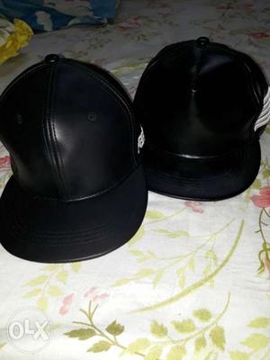 Two Black Leather Flat Brim Caps