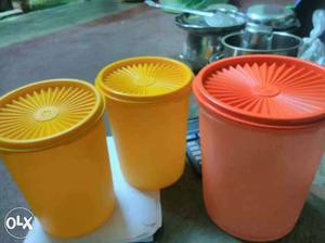 Two Yellow And One Orange Plastic Containers