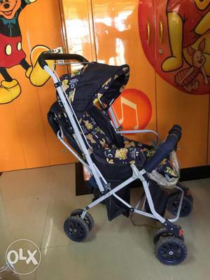 Baby's Blue, Gray, And Yellow Stroller