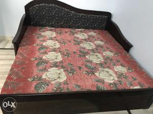 Black Wooden Bed With Red And White Floral Bedspread