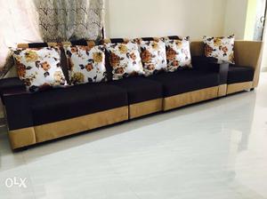 Brown-and-black Sofa Set With Floral Pillows