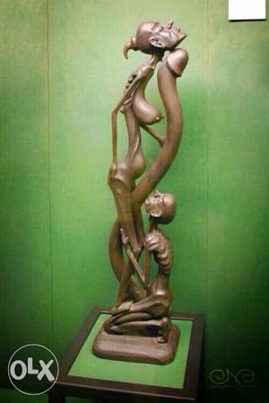 Couple Standing And Sitting Wooden Sculpture