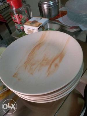 Five Round Beige-and-white Ceramic Plates