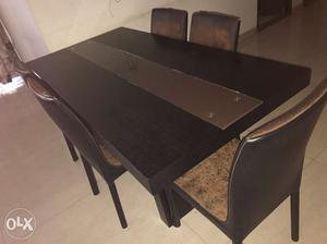 Rectangular Black Wooden Table With 6 Brown Padded Chairs