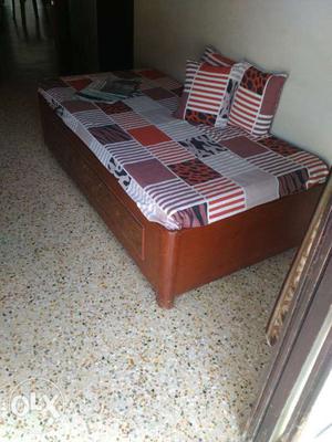 White, Red And Black Mattress With Brown Wooden Bed Frame