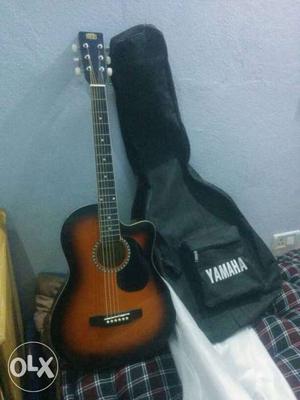 Brown Cutaway Guitar With Black Yamaha Case