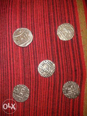 Five Round Silver-colored Coins